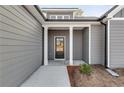 Front entry with gray siding and a dark brown door at 8840 Callaway Dr, Winston, GA 30187