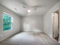 Spacious bedroom with plush carpeting and a large window at 2136 Chadwick Sw Rd, Atlanta, GA 30331
