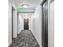 Building hallway with dark doors and carpet flooring at 2870 Pharr Court South Nw # 607, Atlanta, GA 30305