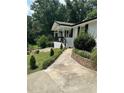 White ranch home with black accents and a paved driveway at 3503 Larkspur Ter, Decatur, GA 30032