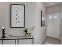 Bright entryway with glass-top console table and art at 5146 Longview Run, Decatur, GA 30035