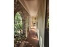 Brick archway porch with view of wooded backyard at 2288 Hudson, Lilburn, GA 30047