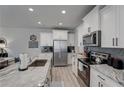 Modern kitchen with white cabinets and granite island at 5150 Longview Run, Decatur, GA 30035