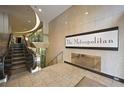 Elegant building entrance with escalator and The Metropolitan sign at 20 Marietta Nw St # 3G, Atlanta, GA 30303