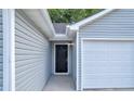 Side entrance to the house and garage with gray siding and black door at 4084 Waldrop Hills Dr, Decatur, GA 30034