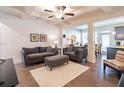 Living room with hardwood floors, ceiling fan, and open concept layout at 263 Auburn Valley Way, Auburn, GA 30011