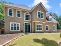 Two-story house with a neutral color exterior and large windows at 144 Wyckliffe Dr, Locust Grove, GA 30248