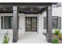 Covered front porch entry with dark brown double doors at 2899 Treeside Terrace, Marietta, GA 30066