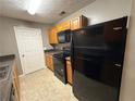 Kitchen with black appliances and wood cabinets at 13104 Fairington Rdg, Lithonia, GA 30038