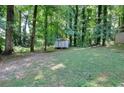 Wooded backyard with a shed, offering privacy and tranquility at 2802 Leisure Woods Ln, Decatur, GA 30034