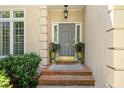 Inviting entryway with gray door, brick steps, and potted plants at 15 Paces West Nw Dr, Atlanta, GA 30327