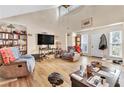 Spacious living room with hardwood floors, vaulted ceiling, and large windows at 5833 Wind Haven Nw Ct, Kennesaw, GA 30152