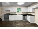 Bright kitchen with white cabinets and dark countertops at 4024 Waldrop Hills Dr, Decatur, GA 30034