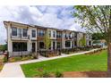 Row of townhouses with white siding and brown accents at 360 Olmstead Way # 24, Alpharetta, GA 30022