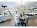 Bright dining room with a round table and a view of the kitchen at 5215 Maggie Mae Ln, Cumming, GA 30028