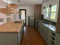 Modern kitchen with butcher block island and green cabinets at 2381 County Line Sw Rd, Atlanta, GA 30331