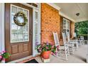 Inviting front porch with rocking chairs and potted plants at 738 Key Largo Ct, Auburn, GA 30011