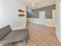 Living room with gray chaise lounge, wood floors, and wainscoting at 388 Oakhaven Way, Villa Rica, GA 30180