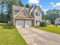 Two-story house with a double garage and a well-maintained lawn at 388 Oakhaven Way, Villa Rica, GA 30180