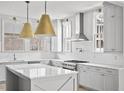 Modern kitchen with white cabinets, marble island, and gold lighting at 100 Ottley Ln, Atlanta, GA 30305