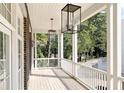 Spacious porch with white railings and elegant lighting at 100 Ottley Ln, Atlanta, GA 30305