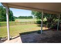 Covered patio overlooking a green space at 1001 S Creek Dr, Villa Rica, GA 30180