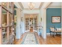 Elegant entryway with hardwood floors, chandelier, and French doors at 1829 Buckhead Valley Ne Ln, Atlanta, GA 30324