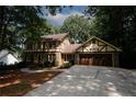Brick Tudor home with attached garage and basketball hoop at 2994 Ravenwolfe Way, Snellville, GA 30039