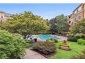 Community pool surrounded by lush landscaping and comfortable seating at 10 Perimeter Summit Ne Blvd # 3412, Brookhaven, GA 30319