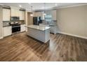 Modern kitchen with an island, stainless steel appliances and hardwood floors at 67 Brookstone W Park, Acworth, GA 30101