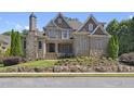 Beautiful brick home with stone accents and a landscaped yard at 850 Camden Park Ct, Atlanta, GA 30342