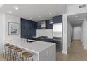 Modern kitchen with white quartz island and dark blue cabinetry at 3325 Piedmont Rd # 2203, Atlanta, GA 30305
