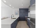 Modern kitchen with white quartz island and dark blue cabinetry at 3325 Piedmont Rd # 2203, Atlanta, GA 30305