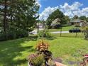Landscaped backyard with a black metal fence, garden, and lush greenery at 635 Beddick Ln, Atlanta, GA 30349