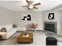 Spacious living room featuring a cozy fireplace and ample natural light at 1054 Valley Rock Dr, Lithonia, GA 30058