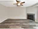 Bright living room with wood-look floors and a corner fireplace at 1054 Valley Rock Dr, Lithonia, GA 30058