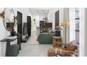 Open concept living area with green sofa and kitchen view at 6305 Shannon Parkway # 206, Union City, GA 30291