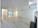 Spacious living room with light gray walls, wood-look floors, and a fireplace at 14 Saint Claire Ne Ln, Atlanta, GA 30324