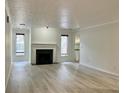 Bright living room with light walls, wood-look floors and a fireplace at 14 Saint Claire Ne Ln, Atlanta, GA 30324