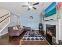 Living room with fireplace, hardwood floors, and large TV at 2314 Rolling Trl, Lithonia, GA 30058