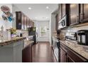 Eat-in kitchen with hardwood floors and ample cabinet space at 2314 Rolling Trl, Lithonia, GA 30058