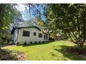 White brick house with black windows and lush lawn at 6733 Walker Rd, Riverdale, GA 30296