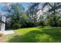 Large backyard with grassy area and patio at 6733 Walker Rd, Riverdale, GA 30296