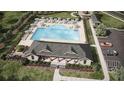Aerial view of community pool, clubhouse, and parking at 8588 Seabiscuit Rd, Lithonia, GA 30058