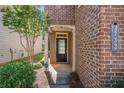 Brick front entrance with a dark brown door and walkway at 3732 Upland Dr, Mcdonough, GA 30253