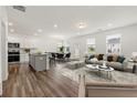 Open concept kitchen and living area with island, stainless steel appliances, and hardwood floors at 2737 Rigby Ln, Duluth, GA 30097