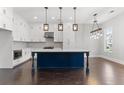 Modern kitchen with white cabinets, a large island, and dark hardwood floors at 1934 Granite Peak Nw Dr, Atlanta, GA 30318