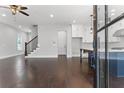 Open concept living room with dark hardwood floors and a staircase at 1934 Granite Peak Nw Dr, Atlanta, GA 30318