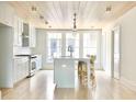 Bright kitchen features white cabinets, marble countertops, and stainless steel appliances at 678 Hank Aaron Dr, Atlanta, GA 30315