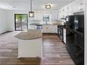 Modern kitchen with granite island and stainless steel appliances at 5351 Zachary Dr, Stone Mountain, GA 30083